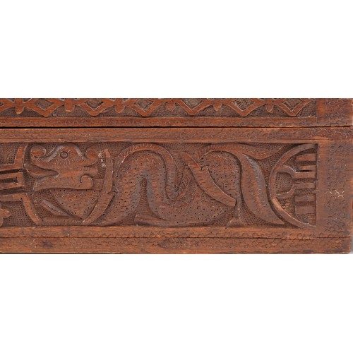 200 - Two oriental hardwood boxes carved with dragons, the largest 7cm H x 28cm W x 17cm D