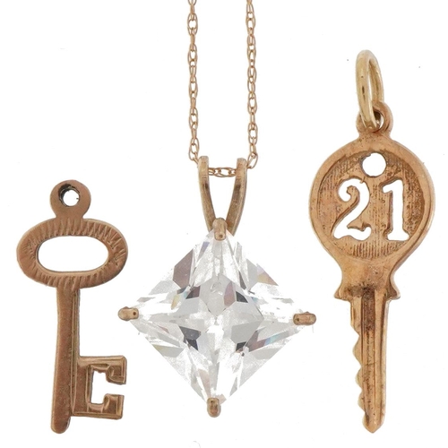 2229 - 9ct gold jewellery comprising cubic zirconia pendant on necklace and two charms in the form of keys,... 