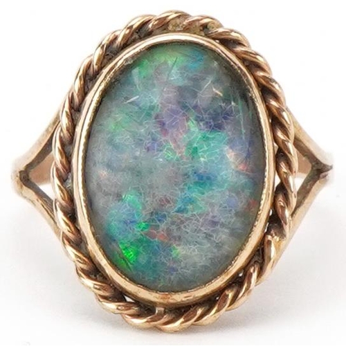 2442 - 9ct gold cabochon opal ring with split shoulders, the opal approximately 14.0mm x 10.0mm x 4.0mm dee... 