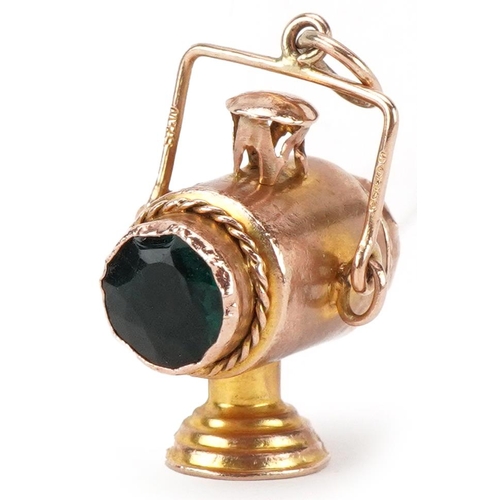 2482 - Large unmarked gold charm in the form of a railway lantern, set with green and red stones, 3cm high,... 