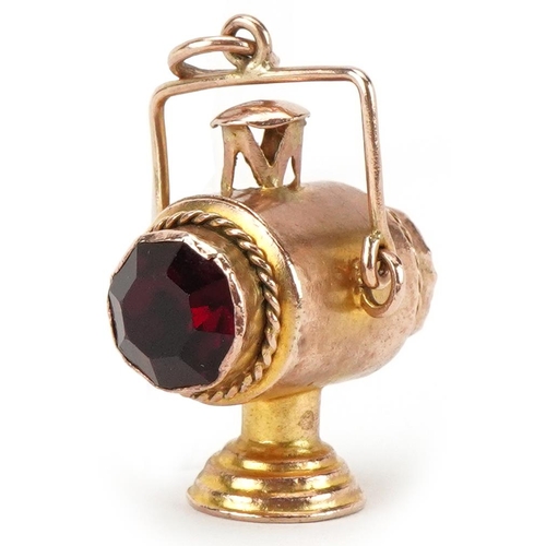 2482 - Large unmarked gold charm in the form of a railway lantern, set with green and red stones, 3cm high,... 