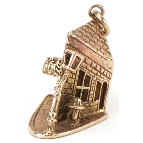 2030 - Large 9ct gold charm in the form of a crooked Pub on the Corner, 2.5cm high, 7.0g