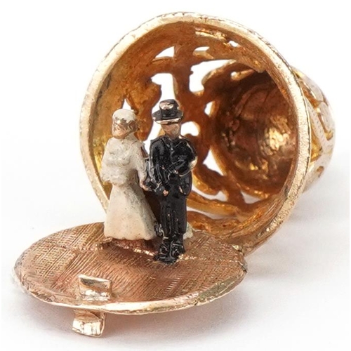 2100 - 9ct gold and enamel charm in the form of a church bell opening to reveal a bride and groom, 2.2cm hi... 