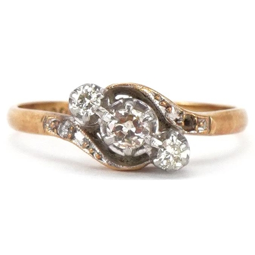 2318 - 18ct gold and platinum diamond three stone crossover ring with diamond set shoulders, total diamond ... 