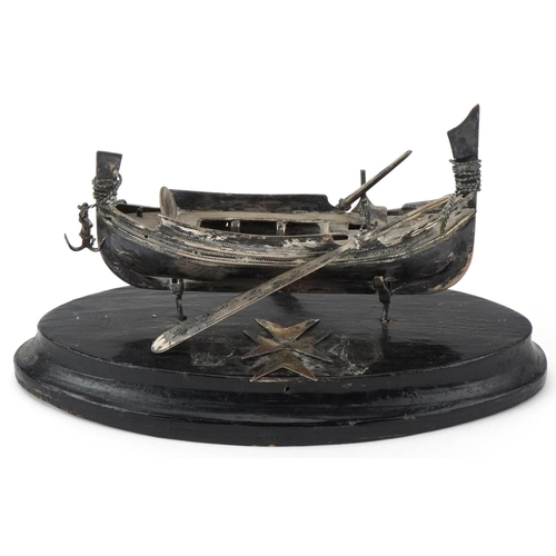 514 - Maltese unmarked silver model of a fishing boat raised on an ebonised wood stand, overall 14cm in le... 