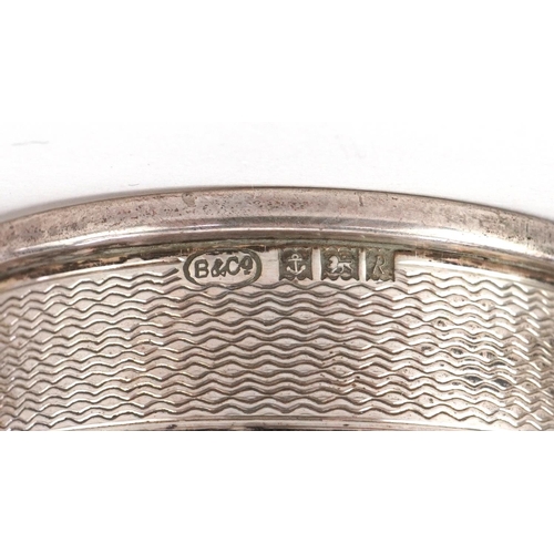 504 - Ten Victorian and later silver napkin rings, some with engine turned decoration, the largest 5cm in ... 