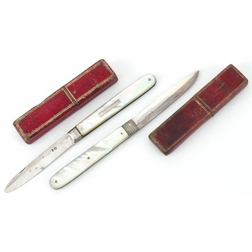 41 - Two Georgian mother of pearl flanked silver folding fruit knives, each housed in a tooled leather fi... 