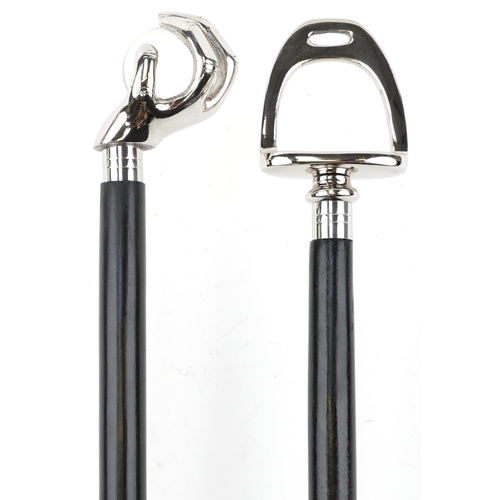 375 - Two ebonised walking sticks with chromed handles, one in the form of a hand holding a crystal ball, ... 