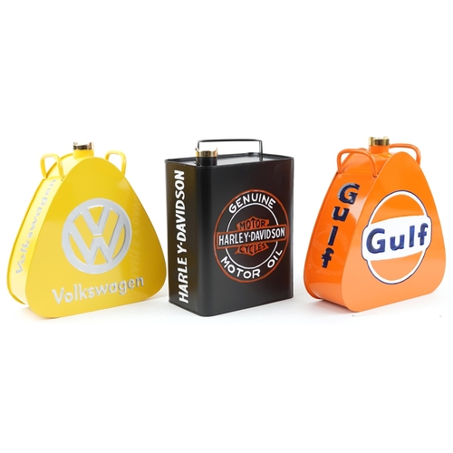 1450 - Three advertising metal fuel cans a Harley Davison, Volkswagen and Gulf, each 34cm high