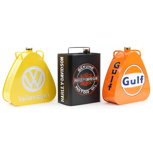 1450 - Three advertising metal fuel cans a Harley Davison, Volkswagen and Gulf, each 34cm high