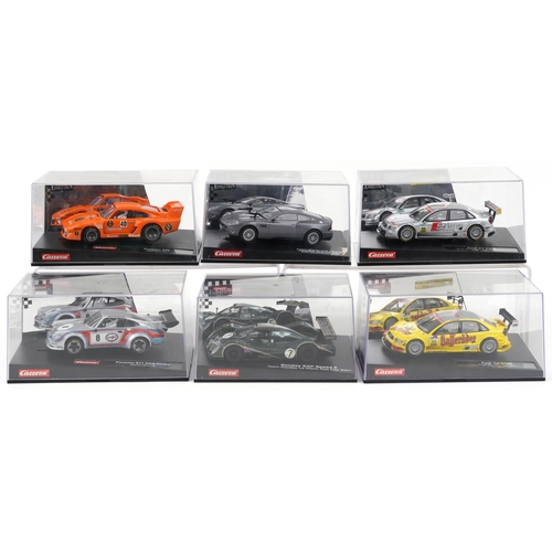 1676 - Six Carrera Evolution slot cars with cases comprising Porsche 935, Aston Martin V12 Vanquis, Audi A4... 