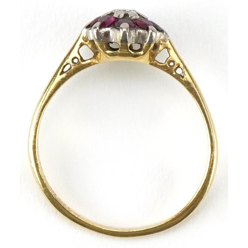 2470 - 18ct gold diamond and ruby flower head ring, the diamond approximately 0.10 carat, size N, 2.6g