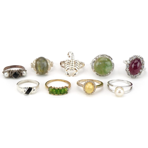 2679 - Nine silver, silver gilt and white metal rings, some set with semi precious stones, including opal, ... 