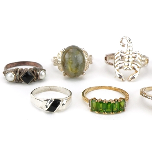 2679 - Nine silver, silver gilt and white metal rings, some set with semi precious stones, including opal, ... 