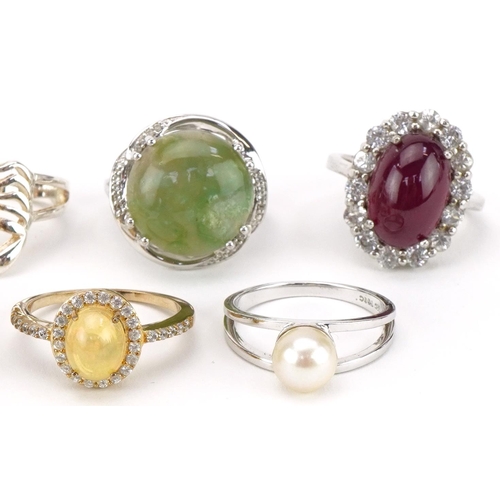 2679 - Nine silver, silver gilt and white metal rings, some set with semi precious stones, including opal, ... 