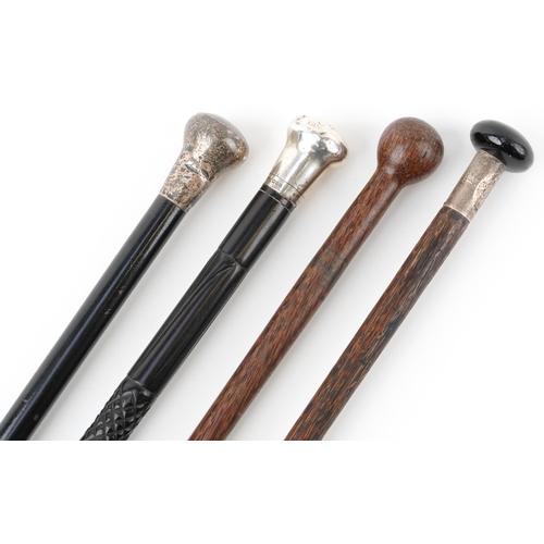 368 - Two ebony silver topped walking sticks and two hardwood walking sticks, three with silver mounts, th... 