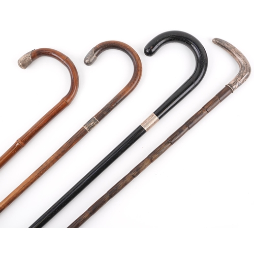 367 - Four silver mounted wooden walking sticks, the largest 90cm in length