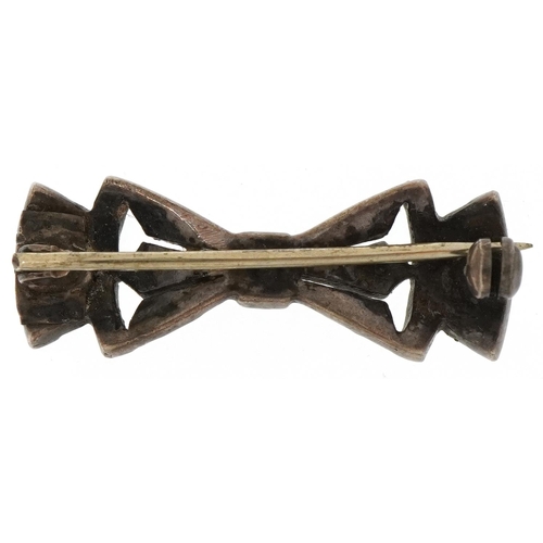 2061 - Art Deco unmarked silver, black enamel and clear stone brooch in the form of a bow, 3cm wide, 4.2g