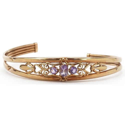 2155 - 9ct gold amethyst openwork bangle, 6cm wide, 6.4g