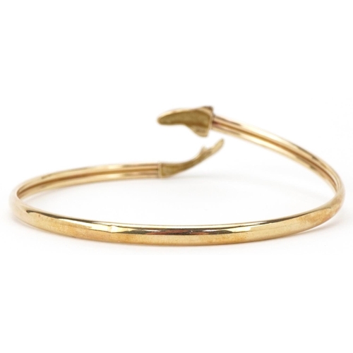 2012 - 9ct gold bangle in the form of a dolphin, 6.5cm in diameter, 6.4g