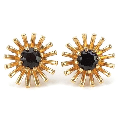 2404 - Pair of 9ct gold garnet starburst stud earrings, each 11mm in diameter, total 2.6g