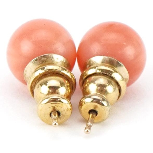 2465 - Pair of yellow metal pink coral stud earrings, each 8.0mm in diameter, total 2.0g