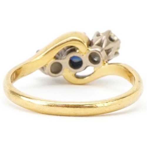 2134 - 18ct gold sapphire and diamond three stone crossover ring, the sapphire approximately 4.30mm in diam... 