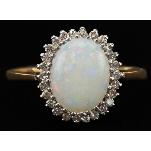 2146 - 9ct gold cabochon opal and diamond cluster ring, the opal approximately 9.80mm x 7.80mm x 2.80mm dee... 