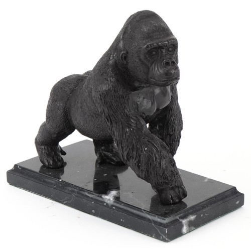 294 - Patinated bronze study of a gorilla raised on a black marble base, 20cm in length