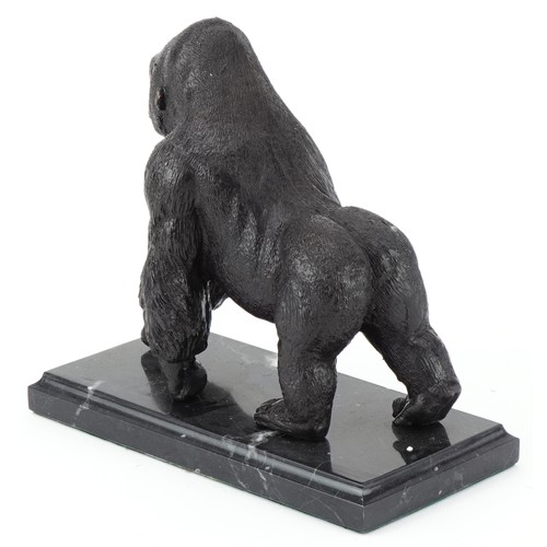 294 - Patinated bronze study of a gorilla raised on a black marble base, 20cm in length