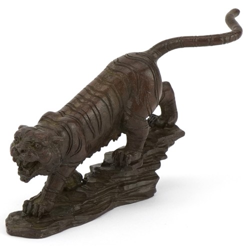 296 - Japanese patinated bronze tiger on a rock, 13cm in length