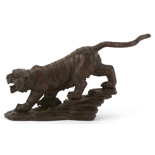 296 - Japanese patinated bronze tiger on a rock, 13cm in length