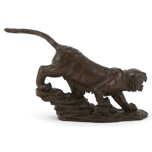 296 - Japanese patinated bronze tiger on a rock, 13cm in length