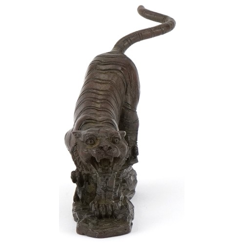 296 - Japanese patinated bronze tiger on a rock, 13cm in length