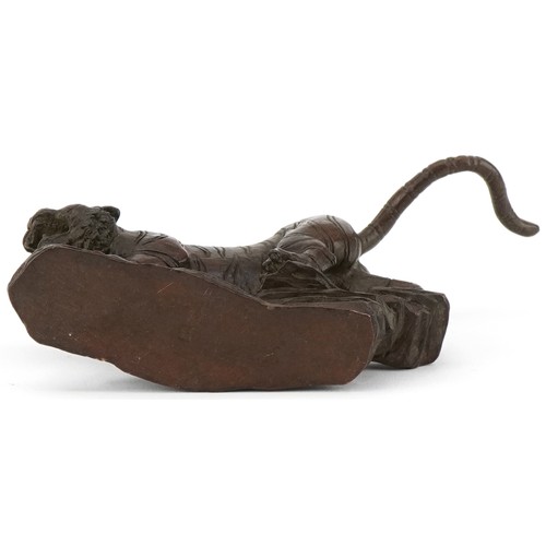 296 - Japanese patinated bronze tiger on a rock, 13cm in length