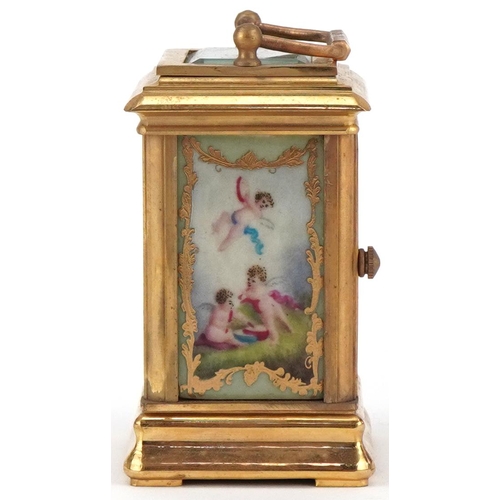 62 - Miniature brass cased carriage clock with Sevres type porcelain panels decorated with Putti, 8cm hig... 