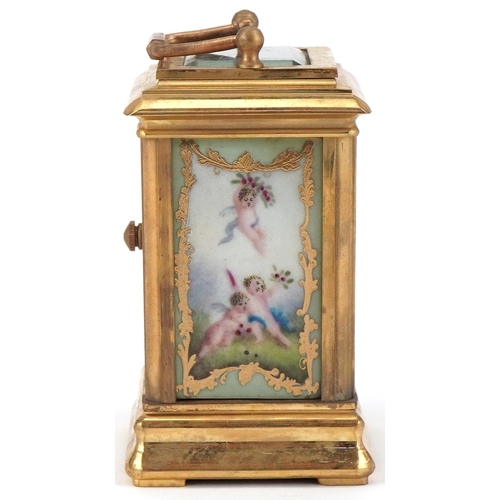 62 - Miniature brass cased carriage clock with Sevres type porcelain panels decorated with Putti, 8cm hig... 