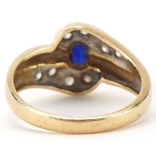 2089 - Modernist 14ct gold sapphire and clear stone crossover ring, size O, 3.8g