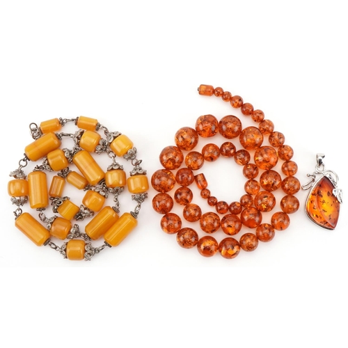 2673 - Natural amber bead necklace, pendant and an amber coloured necklace with white metal mounts, total 2... 