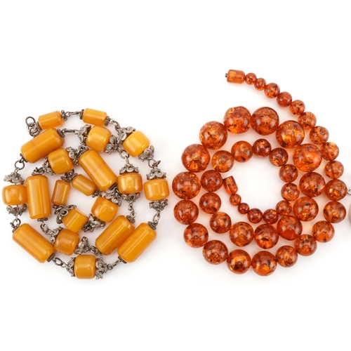 2673 - Natural amber bead necklace, pendant and an amber coloured necklace with white metal mounts, total 2... 