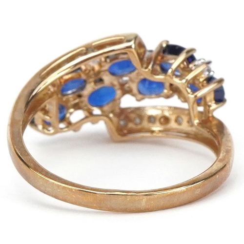 2039 - 9ct gold blue spinel and diamond crossover cluster ring, size P, 2.8g