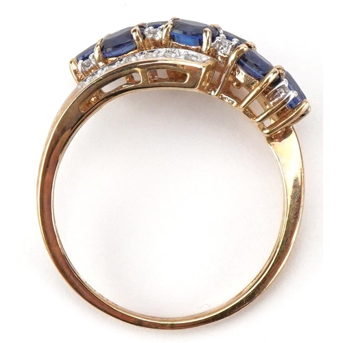 2039 - 9ct gold blue spinel and diamond crossover cluster ring, size P, 2.8g