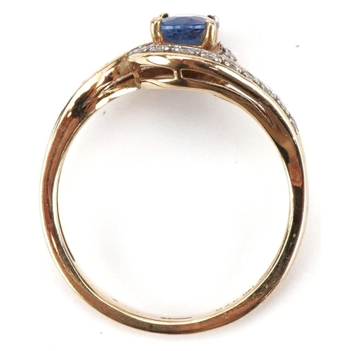 2110 - 9ct gold blue topaz and diamond crossover ring, size P, 2.7g