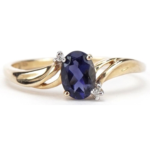 2468 - 9ct gold iolite and diamond three stone crossover ring, size T, 1.9g