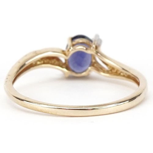 2468 - 9ct gold iolite and diamond three stone crossover ring, size T, 1.9g