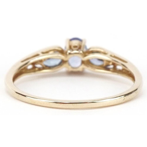 2445 - 9ct gold iolite three stone ring, size T, 2.0g