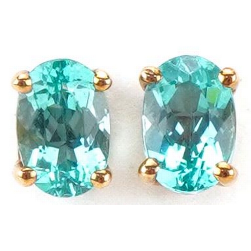 2263 - Pair of 9ct gold blue stone solitaire stud earrings, each 6mm high, total 0.9g