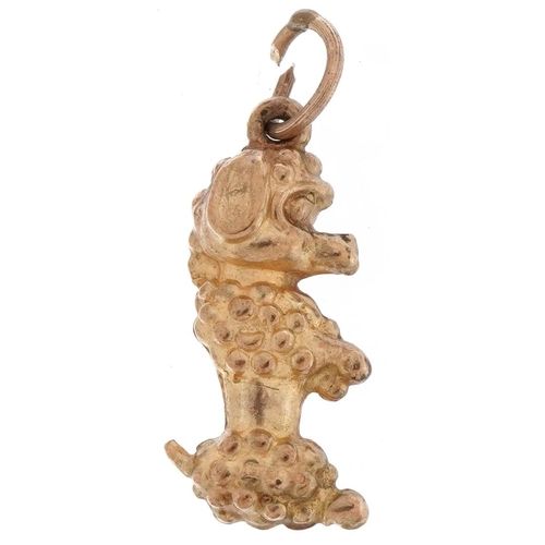 2184 - 9ct gold charm in the form of a seated Poodle, 2.1cm high, 0.8g