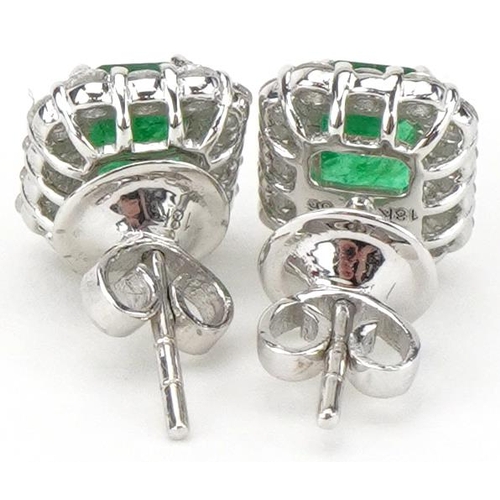 2250 - Pair of 18ct white gold emerald and diamond stud earrings, total diamond weight approximately 0.70 c... 