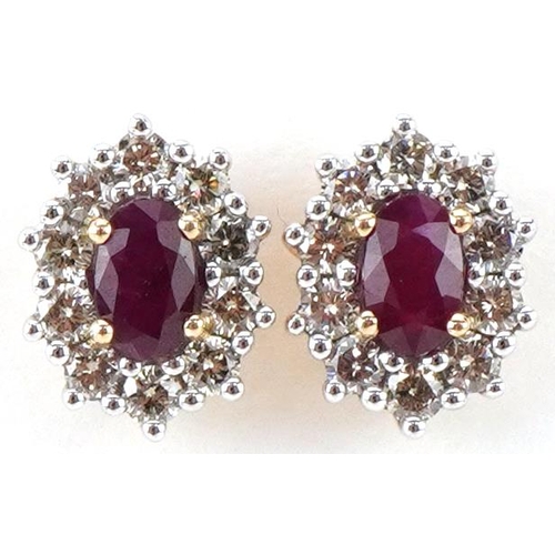 2126 - Pair of 9ct gold ruby and diamond cluster stud earrings, total diamond weight approximately 0.51 car... 